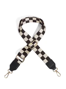 Adjustable black and white checkerboard bag strap with golden metal lobster clasps
