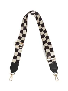 Detail of adjustable checkerboard shoulder strap with gold metal hooks and black leather ends