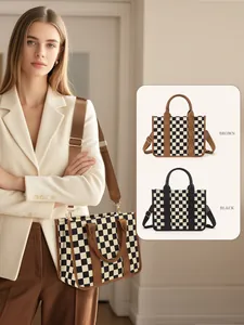 Detail of checkered tote bag showing brown and black canvas textures and shoulder straps