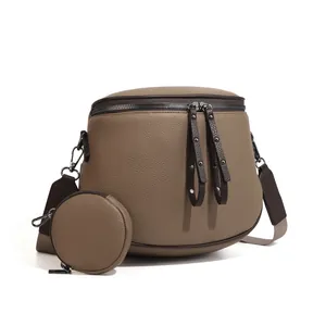 Detail of checkered brown crossbody bag with wide strap and mini round coin purse
