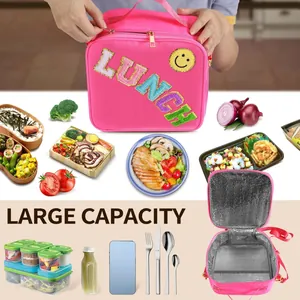 Pink waterproof nylon insulated lunch bag with LUNCH sequin patch and adjustable strap