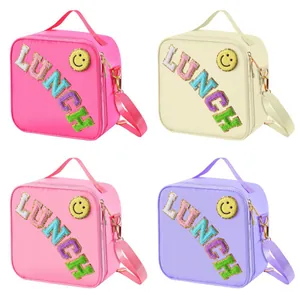 Waterproof nylon insulated lunch bag with LUNCH patches and adjustable shoulder strap
