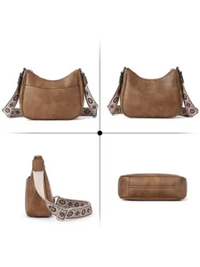 Detailed views of a brown retro crescent bag with a patterned wide shoulder strap