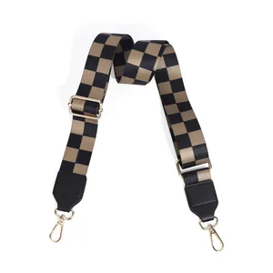 Adjustable checkerboard pattern wide shoulder strap with gold metal hooks and leather ends