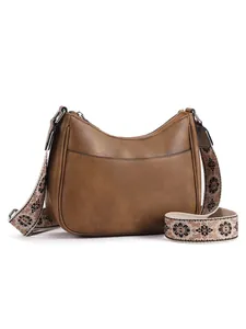 Brown semi-circle hobo bag featuring detail of an ethnic floral patterned woven strap