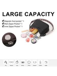 Detailed interior of black pebbled leather crescent bag showing zipper and magnetic pockets