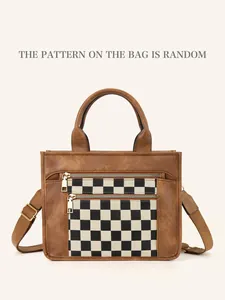 Close-up of brown PU leather bag featuring checkered fabric panels and gold zippers
