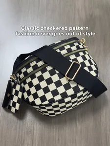 Detail of checkered crossbody bag with gold zippers and matching mini coin purse pouch