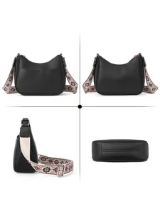 Close-up of black lychee leather crescent bag with adjustable floral strap and flat bottom
