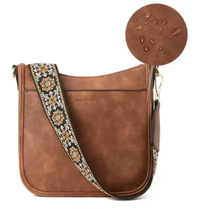 Macro detail of waterproof brown PU leather and patterned embroidery shoulder strap