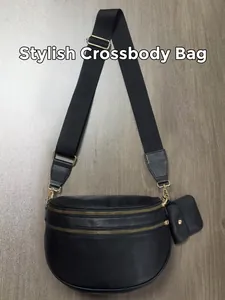 Detail of black suede shell bag with adjustable nylon strap and mini coin purse