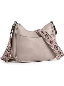 Detail of ivory crescent shoulder bag with wide bohemian pattern adjustable strap