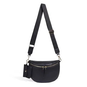 Détail du sac bandoulière noir grainé avec zips dorés et mini pochette amovible