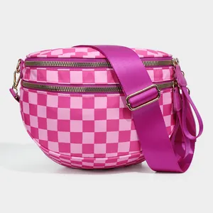 Detailed shot of pink checkerboard nylon bag with dual zippers and purple strap