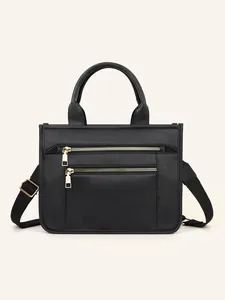 Front view of black PU tote bag with double metal zippers and wide fabric shoulder strap