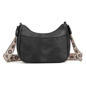 Detail of black pebbled leather crescent bag with floral embroidery wide strap