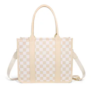 Close-up of checkerboard tote bag featuring reinforced handles and adjustable strap detail