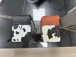 Detail of PU leather cow print card holder wallets with zipper closure and keychains
