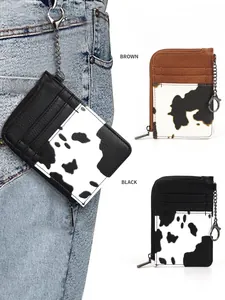 Slim cow print card holder wallet with multiple slots and metal keychain on jeans