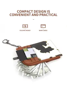 Detail showing cow print leather card holder with multiple slots and zipper pocket