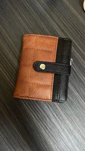 Detailed view of checkered fold card wallet with quilted pattern and gold buckle