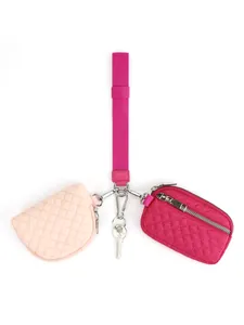 Detail of pink quilted wristlet set with lanyard, round pouch and card wallet