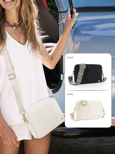 Quilted waterproof crossbody bag with geometric jacquard strap in black and white