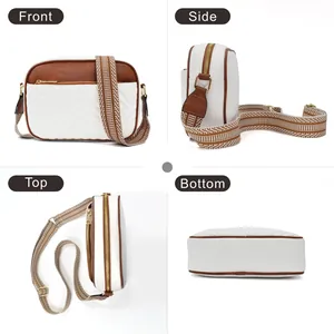 Crossbody camera bag with cow print, V-quilting, striped strap, and gold hardware detail
