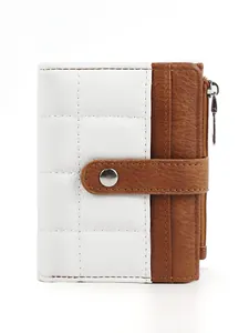 Detail of quilted white and brown leather wallet with snap button and side metal zipper