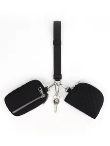 Detail of black quilted wristlet strap with multi-functional zipper pouches and key ring