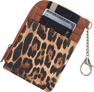 Detail view of leopard print card holder with zipper pocket and metal keychain