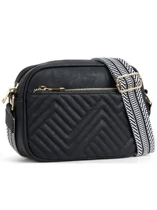 Detail of black chevron quilted crossbody bag with gold zipper and woven strap