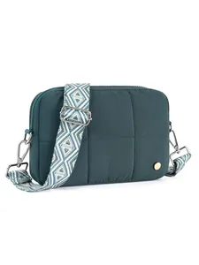 Close-up of quilted nylon crossbody bag with adjustable ethnic pattern woven shoulder strap