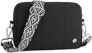 Detail of black quilted crossbody bag with stylish geometric pattern wide strap