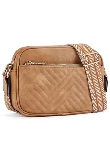 Detail of V-quilted faux leather camera bag in brown with wide geometric strap