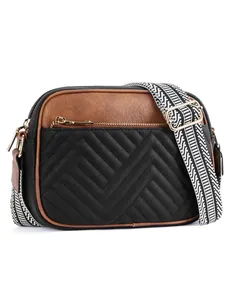 Detail of chevron quilted faux leather camera bag with a wide geometric patterned strap
