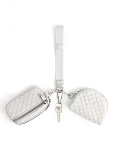 Close-up of three-in-one wristlet pouch set with quilted zip wallets and fabric strap