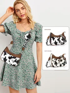 Detail of trendy cow print crescent bag set with adjustable wide strap and coin purse