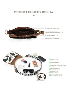Internal view of cow print hobo bag showing spacious compartments and zip pockets