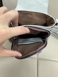 Dettaglio interno della mini borsa a tracolla con tre scomparti per carte e tessuto grigio