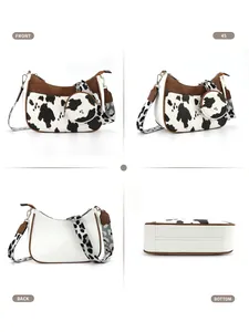 Detail view of crescent crossbody bag with cow print pattern and adjustable woven strap