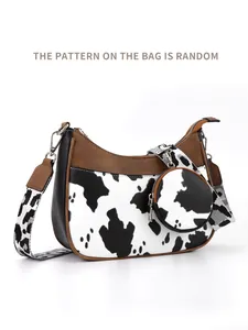 Detail of crescent shoulder bag with cow print pattern and adjustable wide strap