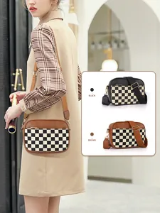 Detail of checkered crossbody camera bags in black and brown with adjustable straps