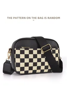 Detail of checkered crossbody bag with adjustable wide strap and gold zipper hardware