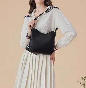 Classic black leather hobo shoulder bag styled with an elegant minimalist outfit
