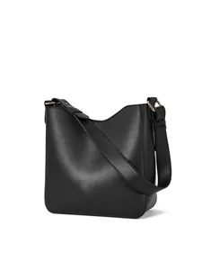 Close-up of minimalist black leather bucket bag with premium gold metal hardware detail