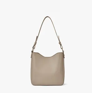 Detail of khaki hobo bucket bag with adjustable strap and premium pebble leather texture