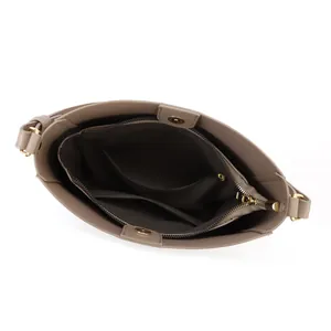 Top view showing the internal multi-layer structure and gold hardware of the taupe bucket bag