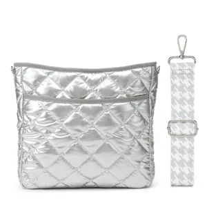 Detail of silver metallic quilted crossbody bag with a houndstooth wide strap