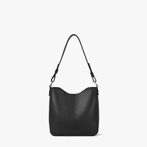 Minimalist black leather bucket bag with smooth matte finish and gold hardware accents